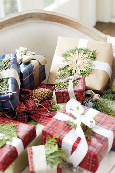 presents wrapped in plaid and tied with white ribbons, pine cones, and evergreens