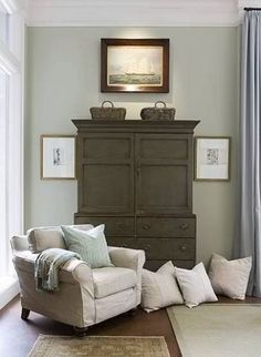 a living room filled with furniture and a painting on the wall above it's headboard