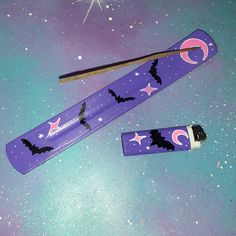 two toothbrushes with bats and stars on them are laying next to each other