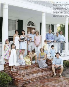 the thomass family on their porch in front of their house, which is for sale