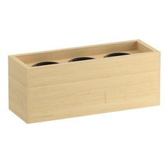 a wooden box with two black cups in it