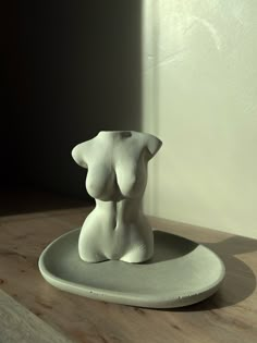 a white sculpture sitting on top of a plate