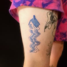 a person with a tattoo on their leg has a horse and water design on it