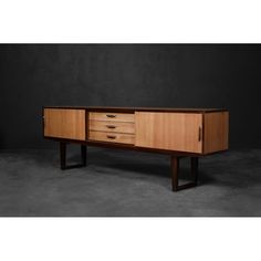 the sideboard is made from wood and has three drawers on one end, two at the