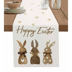 an easter table runner with three bunnies on it and the words happy easter written in brown