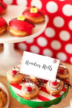 a table topped with lots of donuts covered in frosted icing and santa hats