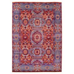 an orange and blue rug with many different designs on it, including squares and circles