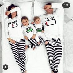 the family is wearing matching pajamas while laying in bed