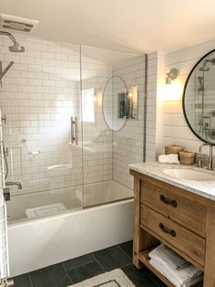 a bathroom with a sink, mirror and bathtub next to a walk in shower