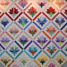 a colorful quilt hanging on the wall