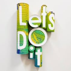 the letters let's do it are made out of plastic cups and plates