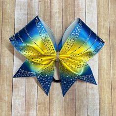 "This rhinestone bow make a perfect competition bow!    Shown in aqua and yellow ombré with clear stones. This bow is available in any color combo. Badda Bling Bows provides the highest quality bows on the market specializing in cheer bows, practice bows, competition bows, softball bows, dance bows, rhinestone bows, school bows, sideline cheer and team bows. We also uniform match.   Want a different color? Fabric colors shown in the shop can be mixed and matched, simply put your color preference Perfect Competition, Dance Bows, School Bows, Softball Bows, Yellow Ombre