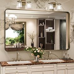 a bathroom with two sinks and a large mirror on the wall above it is shown