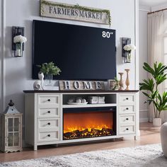 a living room with a large television and fireplace