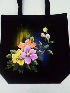 a black bag with flowers painted on it