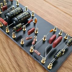 an electronic board with many different types of electrical components on it, including capacitors and tubes