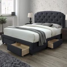 a bed with drawers underneath it in a bedroom