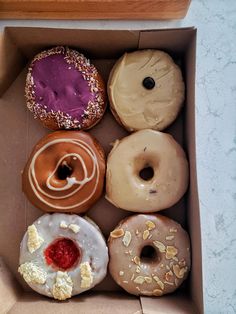 a box filled with different types of donuts