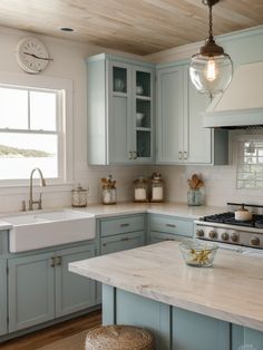 a kitchen with blue cabinets and white counter tops