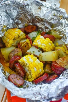 corn on the cob and sausage wrapped in foil