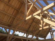 the inside of a building with wooden beams and roof trusses on it's sides