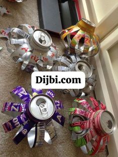 several cans and cans are on the floor next to each other with ribbons around them