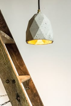 a wooden ladder with a light hanging from it