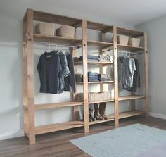 a wooden shelf filled with clothes and baskets