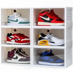 six pairs of nike sneakers are in a white display case with four different colors and sizes