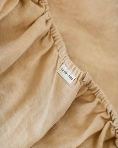 a close up view of the back of a linen material with a label on it