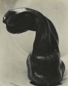 a black cat statue sitting on top of a table