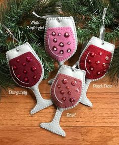 three wine glasses hanging from a christmas tree