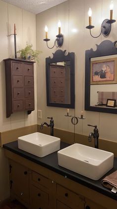 two sinks are in the middle of a bathroom with mirrors on the wall above them