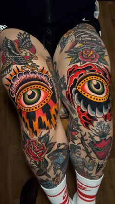 the legs are decorated with tattoos and an eye