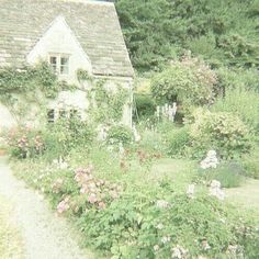 an old photo of a house surrounded by flowers