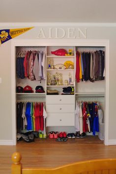 an open closet with clothes and shoes on the shelves in front of it that says arden