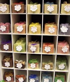 a shelf filled with lots of different types of soaps and presents on top of it