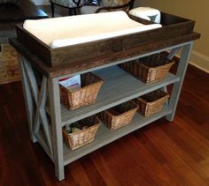 a baby changing table with baskets on top