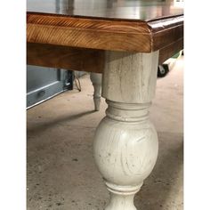 a white table with wood top in a room