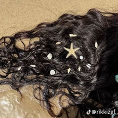 the hair is laying on the floor with starfishs and seashells attached to it