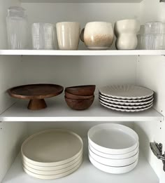 plates and bowls are sitting on the shelves