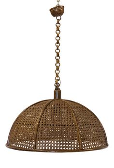 a light that is hanging from a chain on a white background and has a brown rattan finish