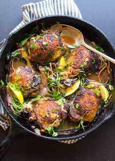 a skillet filled with chicken and vegetables