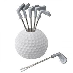 a white golf ball with six tees and a putter's club in it