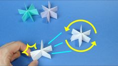 origami stars and arrows on a blue background with yellow circle in the middle