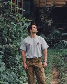 a man standing in front of some plants