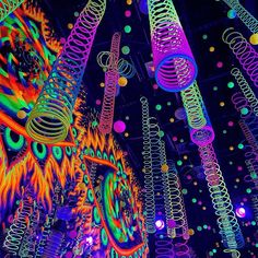 colorful lights and spirals are hanging from the ceiling in an art installation at night