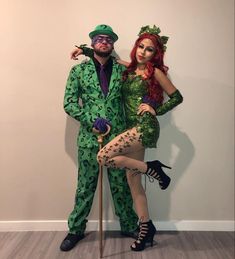 a man and woman dressed up as the riddle and the person in the green suit