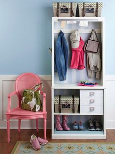 a pink chair sitting in front of a white book shelf filled with clothes and shoes