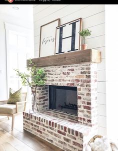 a living room with a brick fireplace and white walls